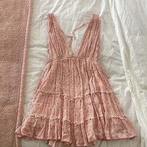 Pink and white mini dress with open tie back and exposed on the sides